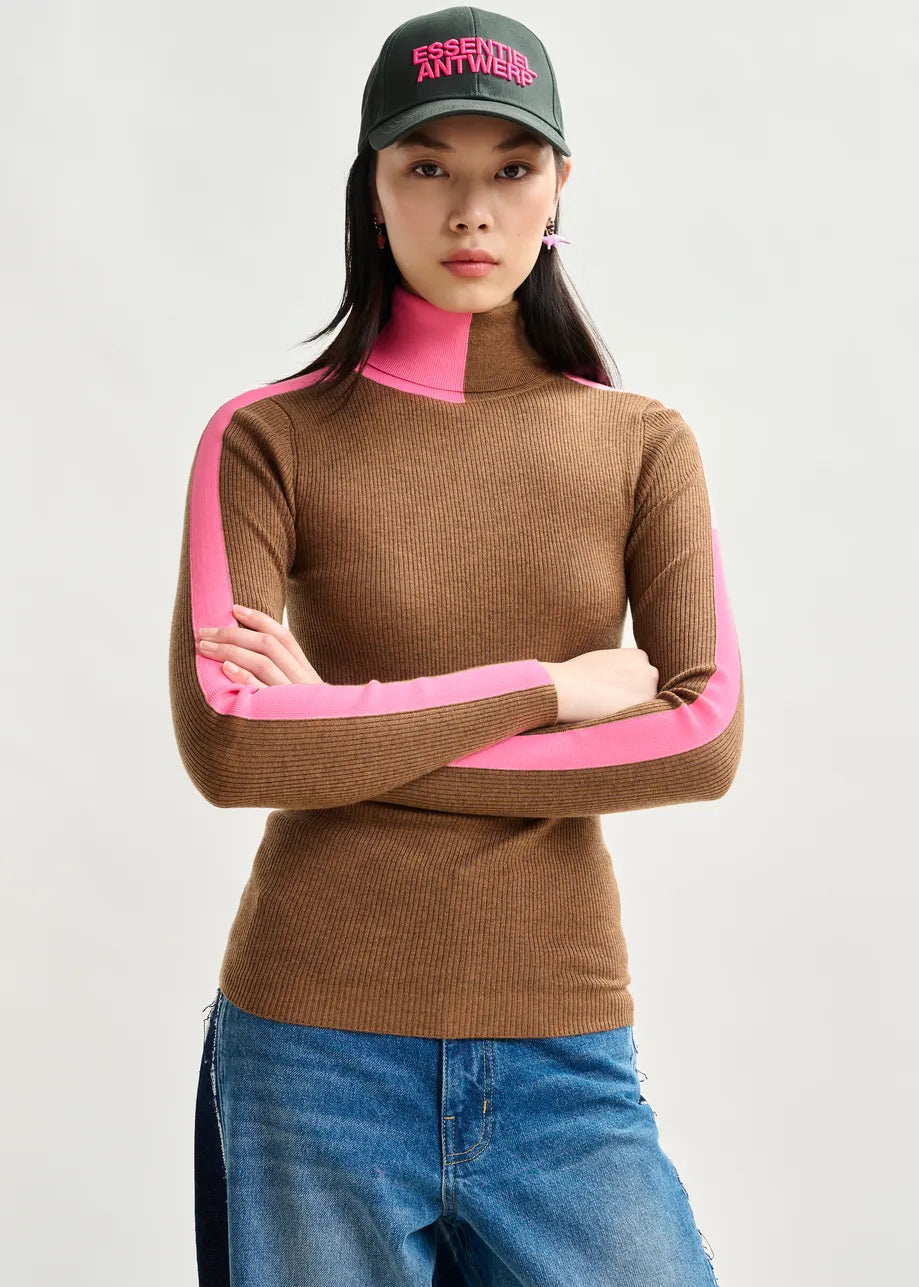 Person wearing a brown sweater with pink sleeves and a cap on a white background