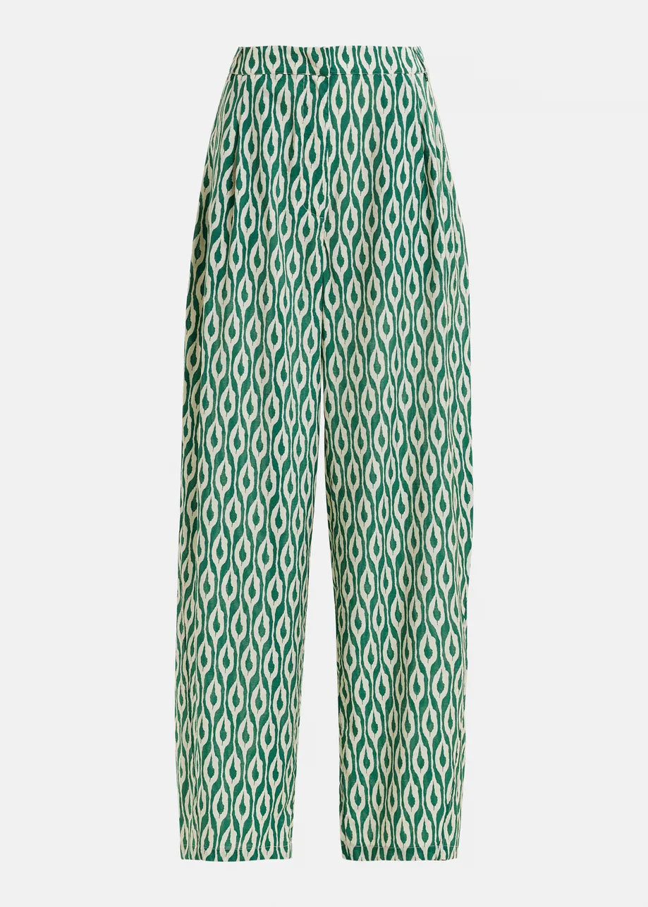 Green and white patterned pants on a light gray background