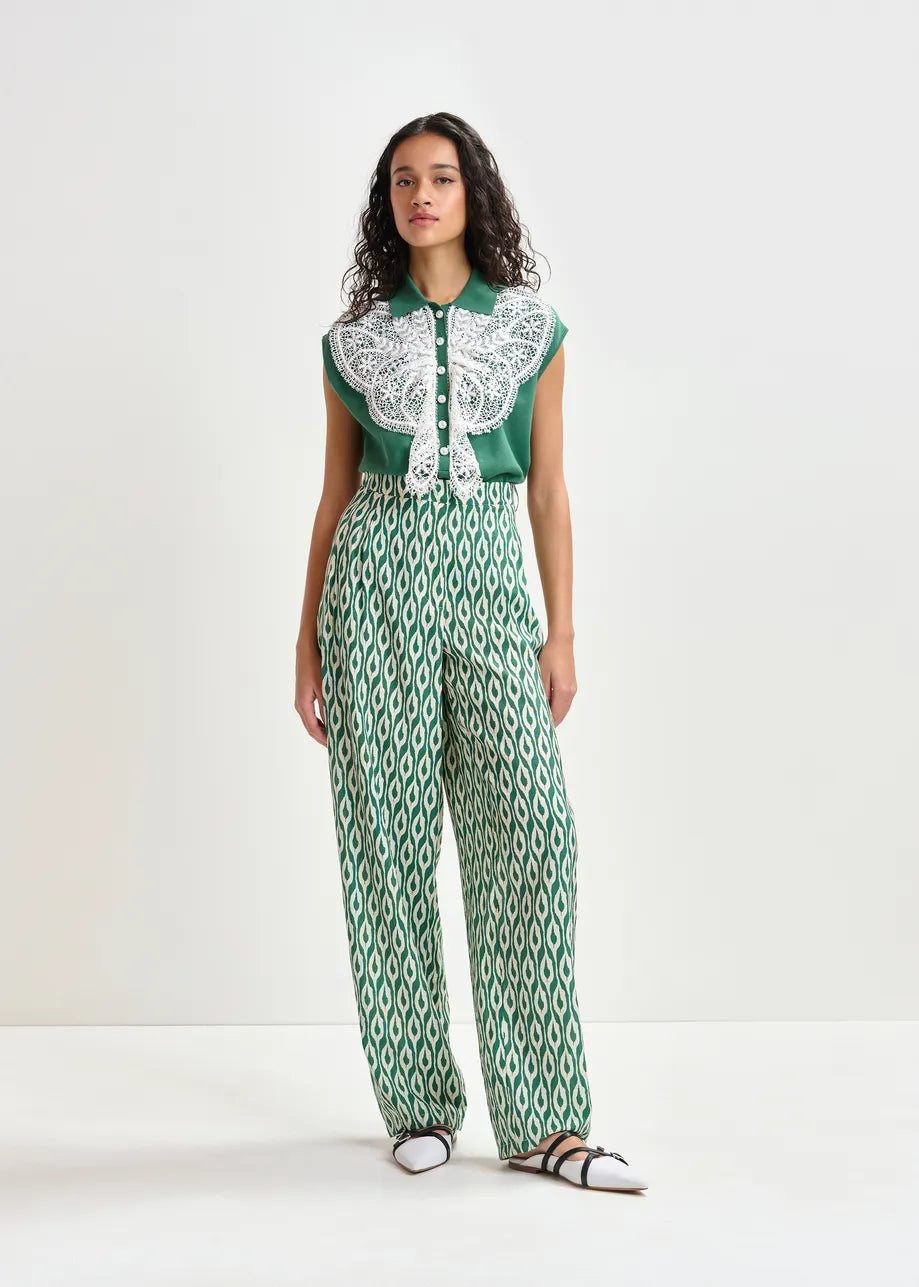 Woman wearing a green and white patterned outfit on a white background