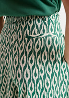 Green and white patterned pants with a pocket detail.