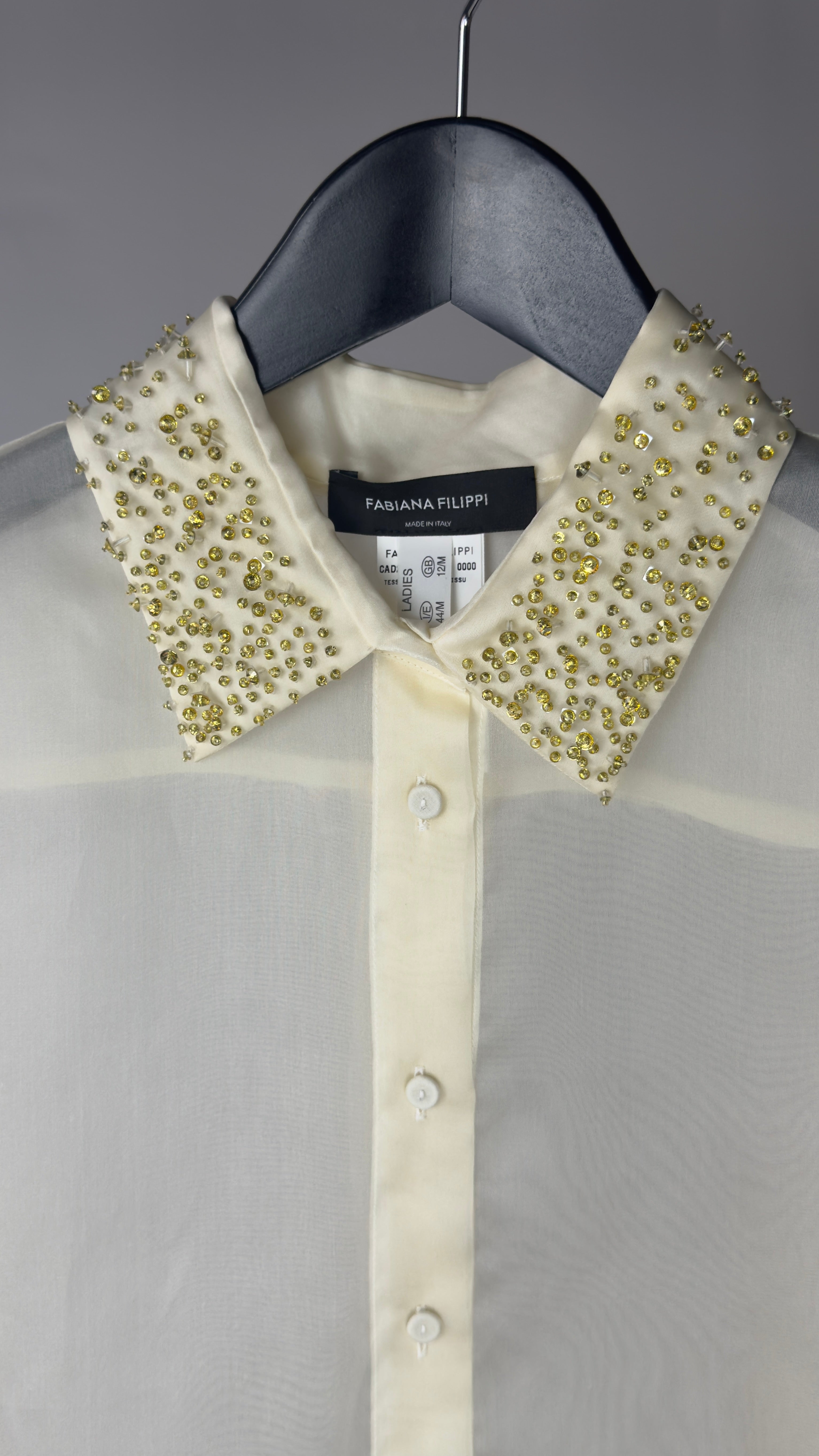 White shirt with embellished collar on a hanger, brand label visible