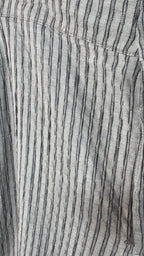 Close-up of a fabric with black vertical stripes on a gray background