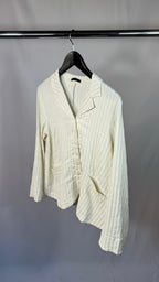 White ribbed knit cardigan on a hanger against a plain background