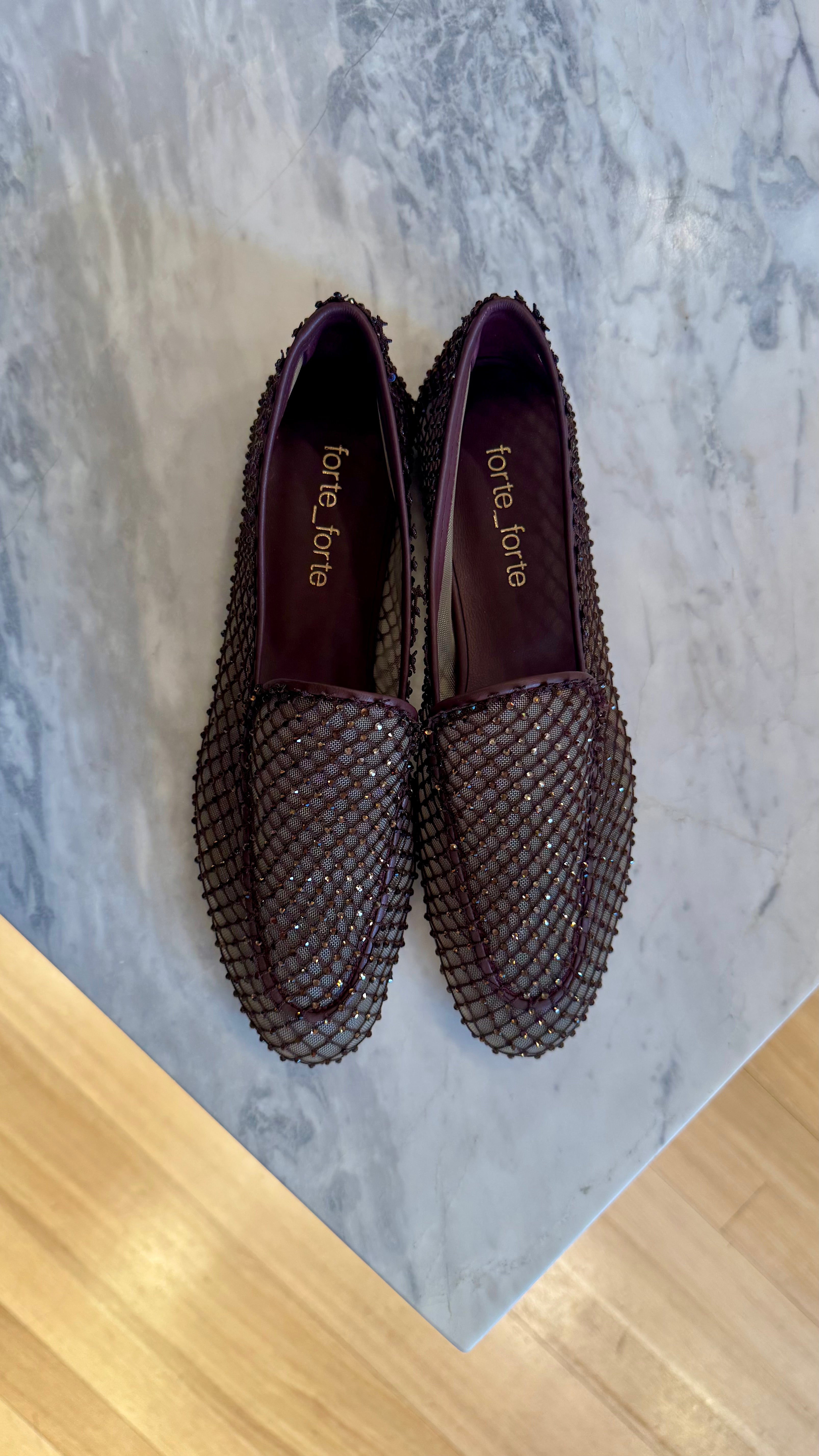 Pair of mesh loafers on a marble surface