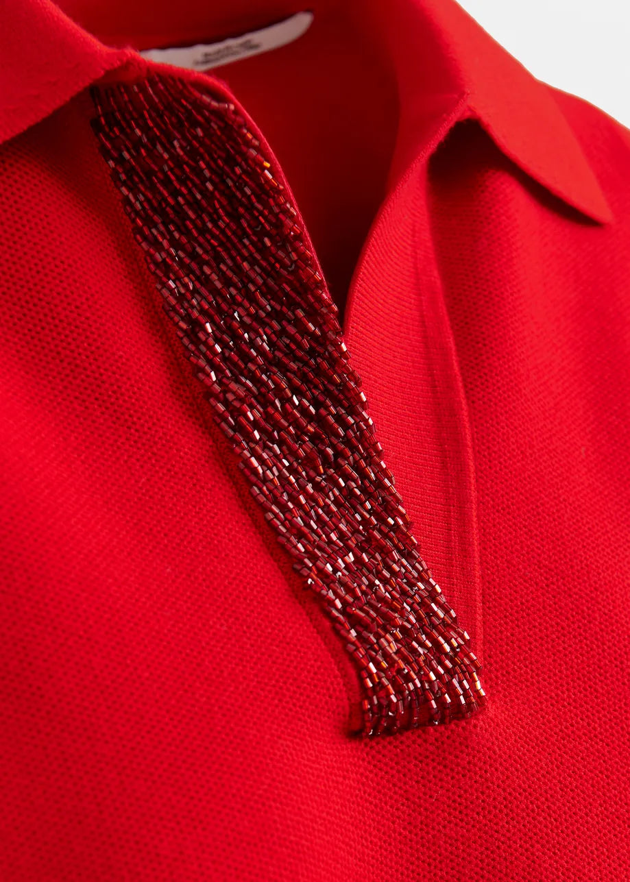 Red polo shirt with a decorative red tie on a white background