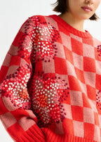 Red checkered sweater with heart patterns worn by a person