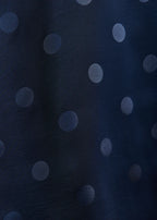 Navy blue fabric with light gray polka dots