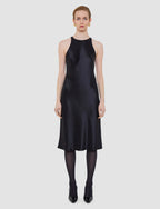 Woman wearing a black dress on a white background