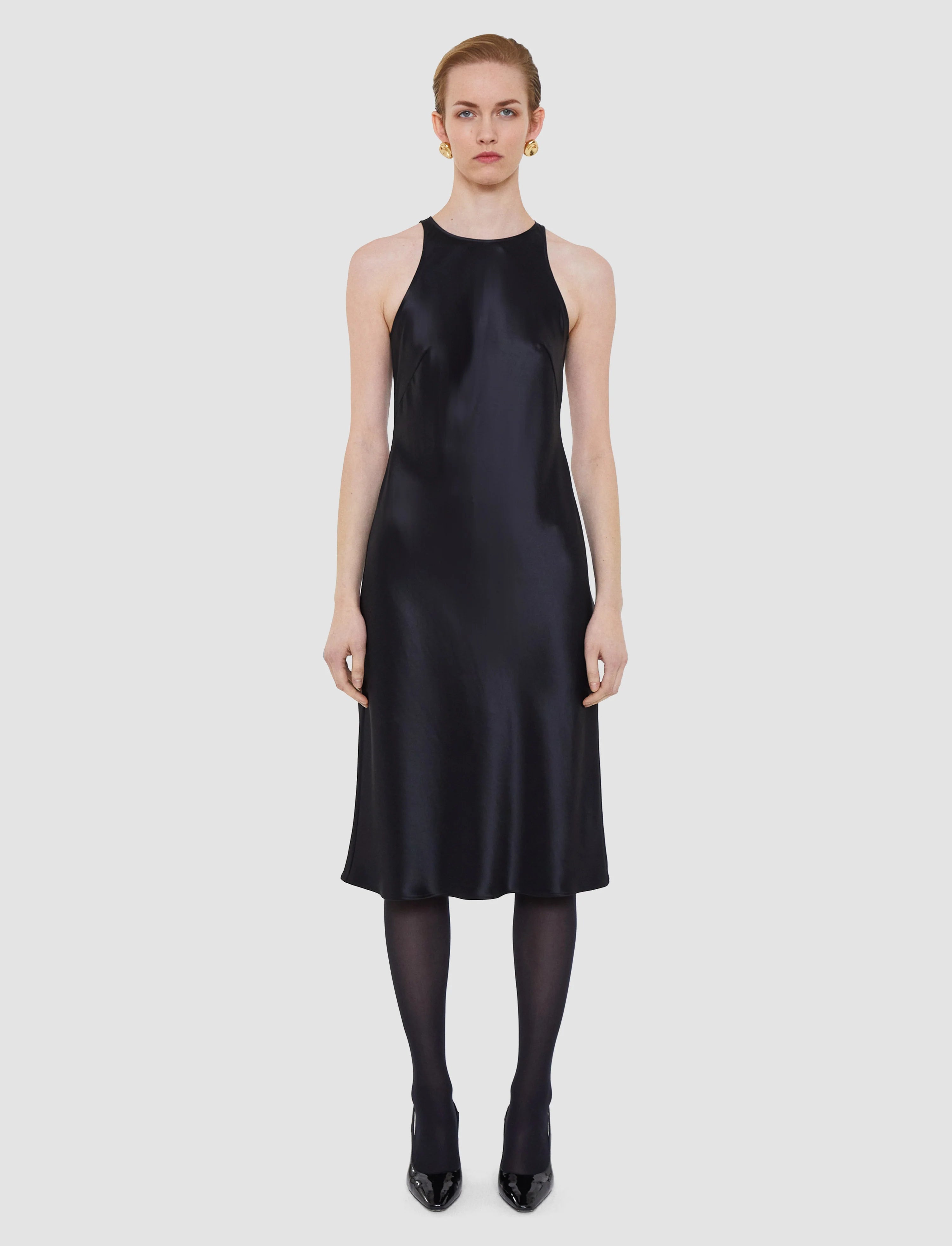 Woman wearing a black dress on a white background