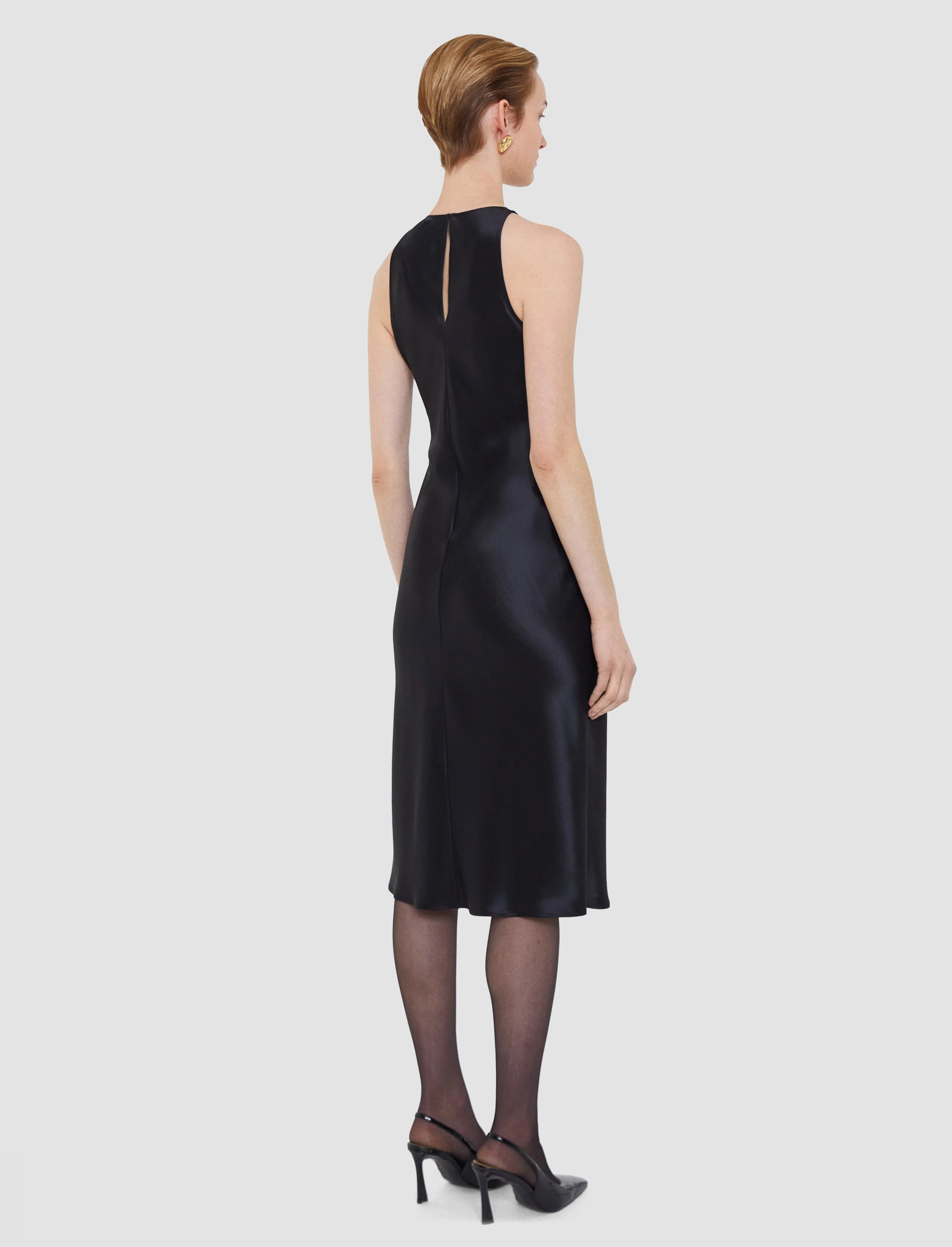 Woman wearing a black dress on a white background