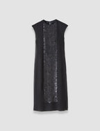 Black dress with sequin panel on a light gray background