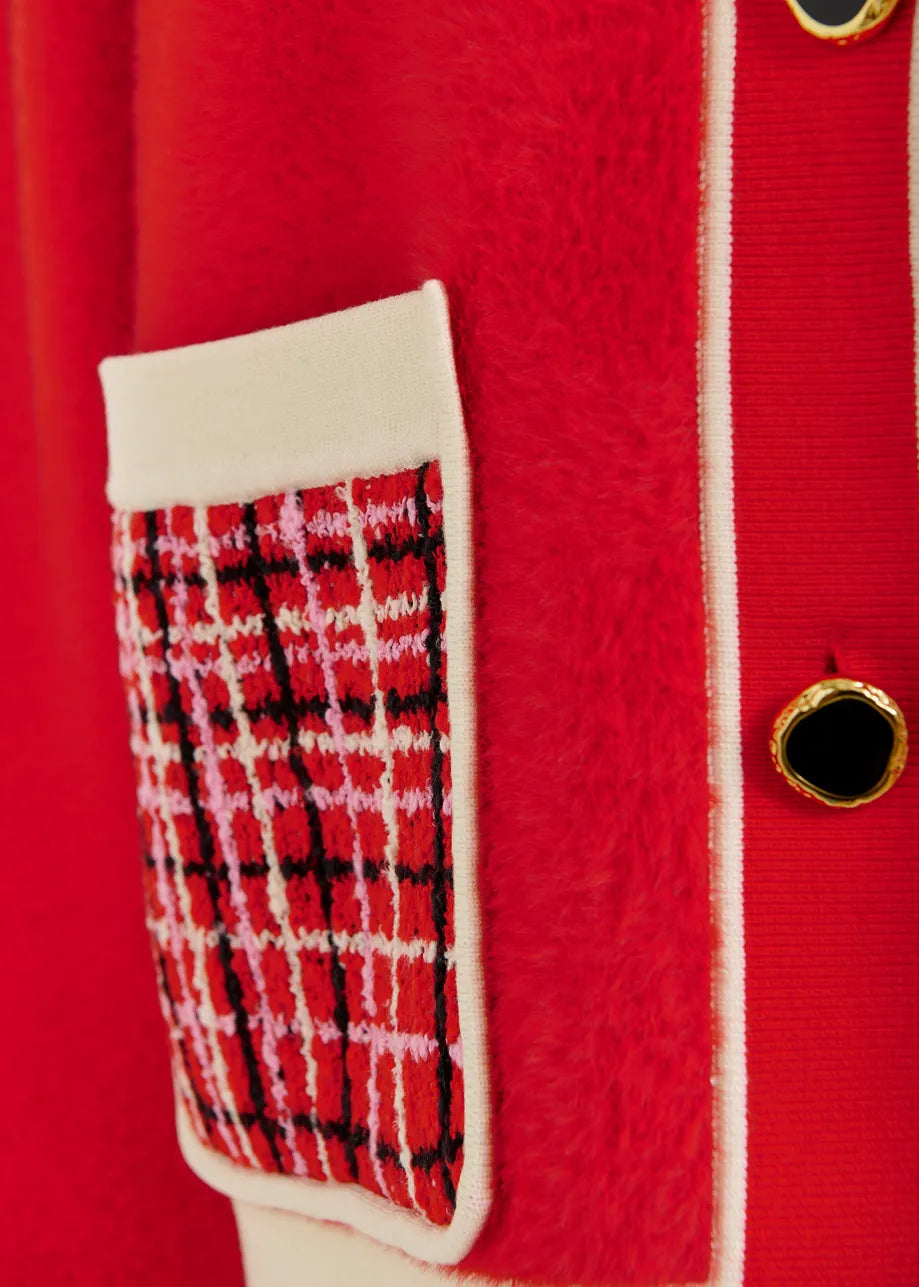Red coat with a plaid patterned patch on a red background