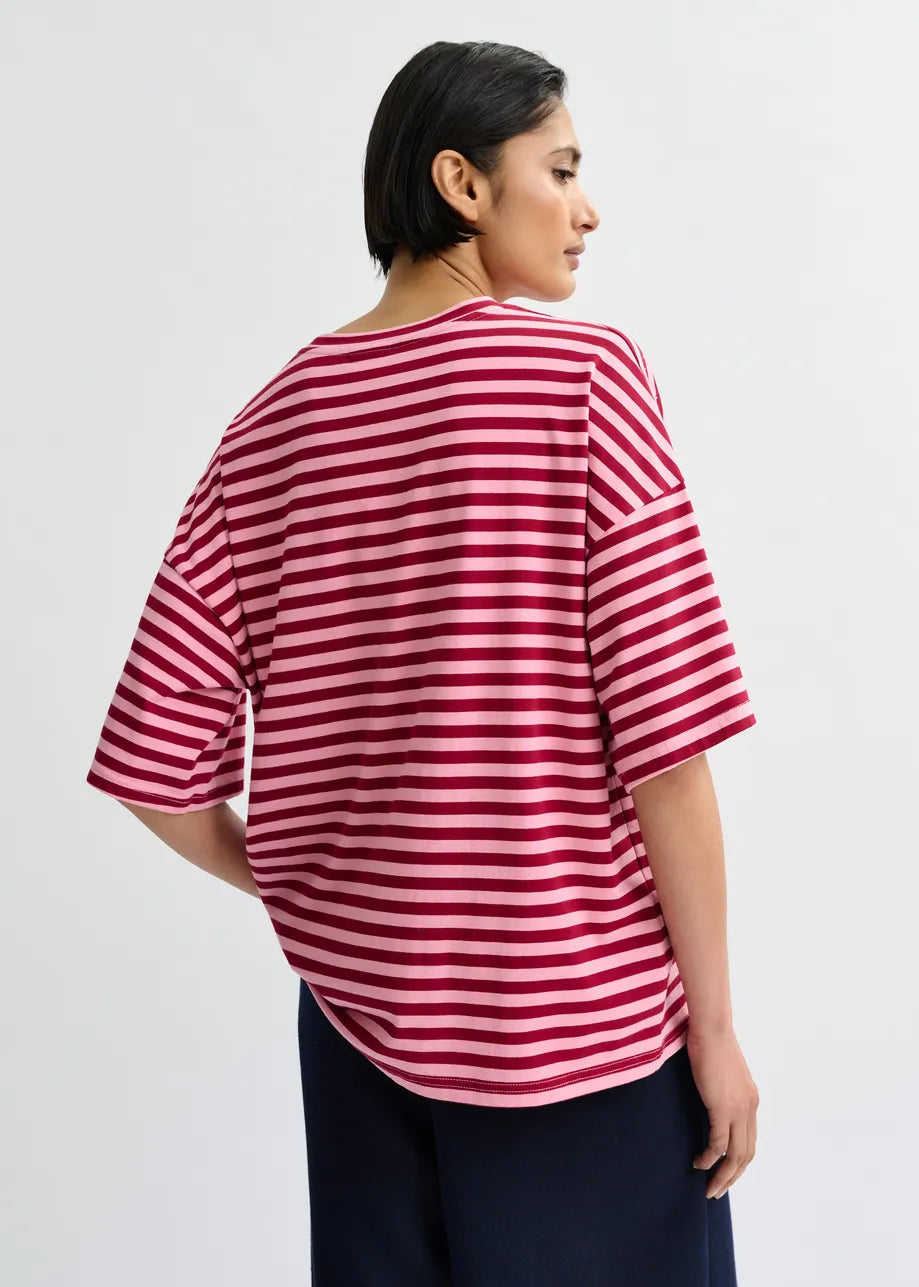 Person wearing a red and white striped shirt on a plain background