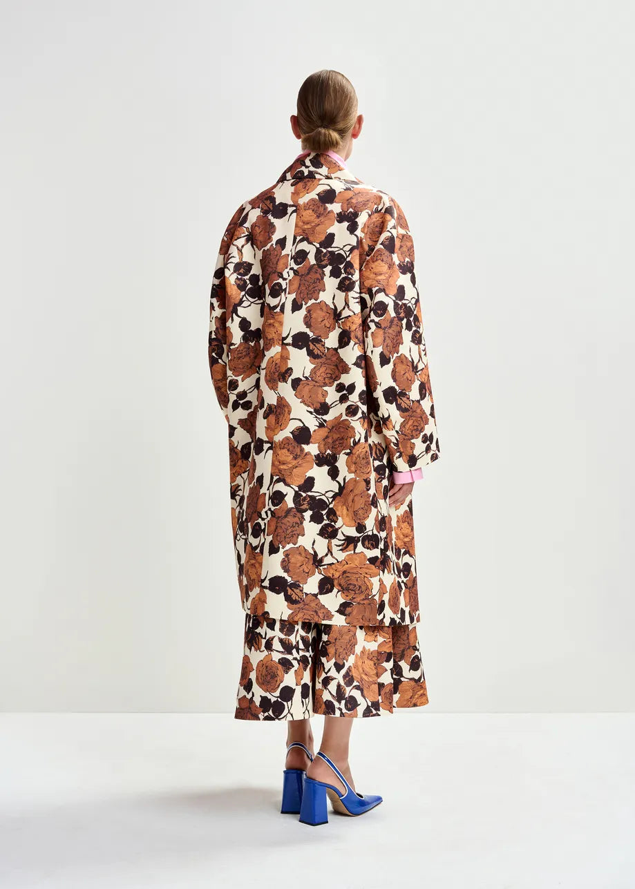 Woman wearing a floral dress with a white background