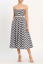 A midi dress with a geometric zigzag pattern, featuring a tie-front neckline, a fitted bodice, a cinched waist with a roped belt, and a gathered waistband. It has a strappy open back and a zip fastening at the back.