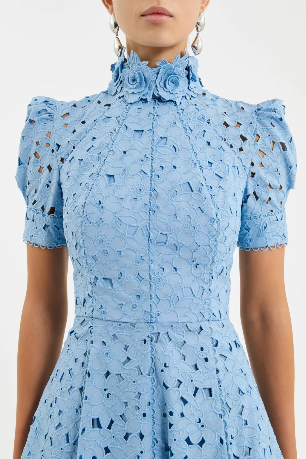 Light blue dress with floral details and cut-out patterns on a plain background