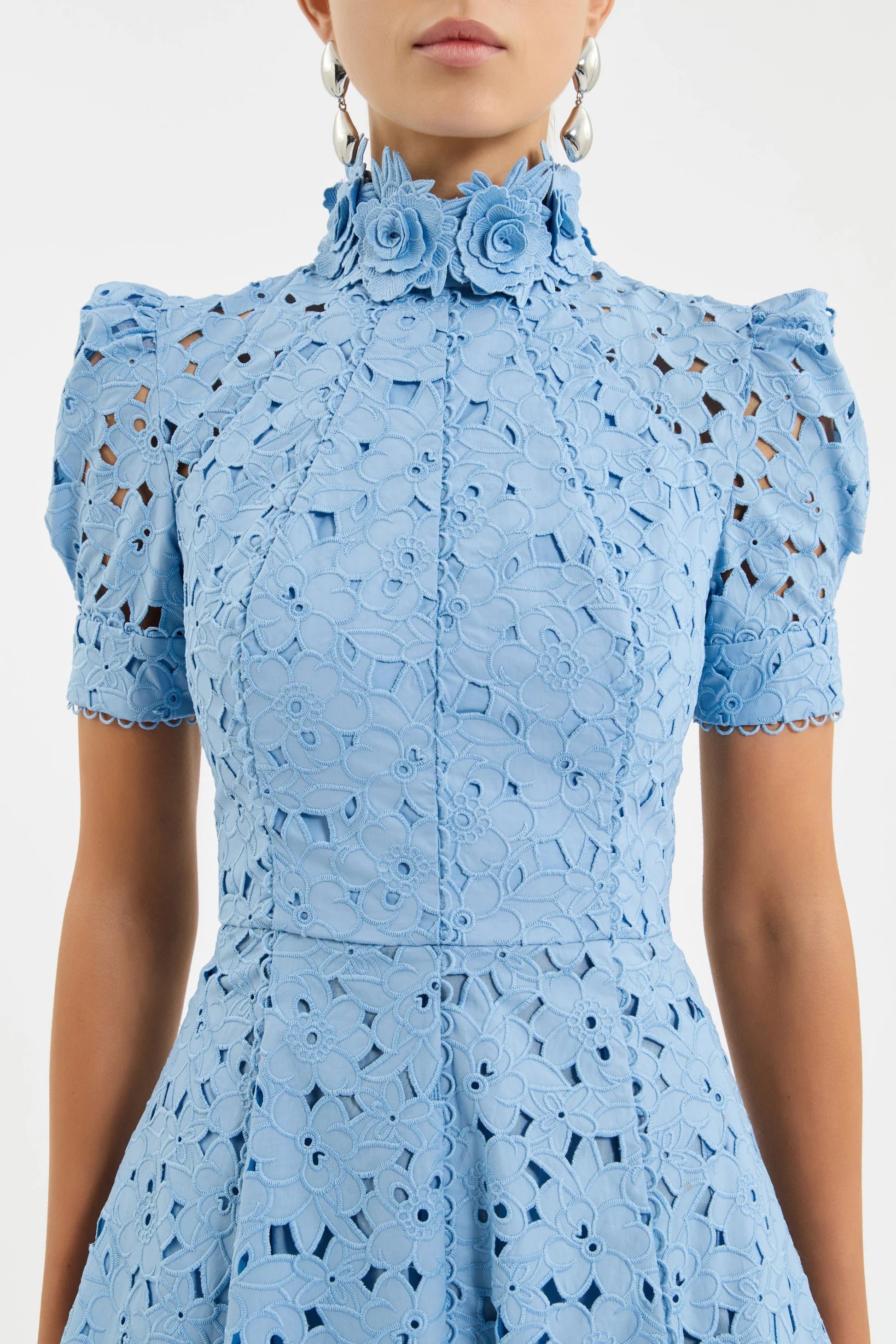 Light blue dress with floral details and cut-out patterns on a plain background