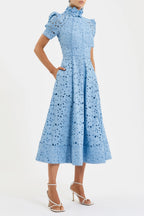 Woman wearing a light blue lace dress on a white background