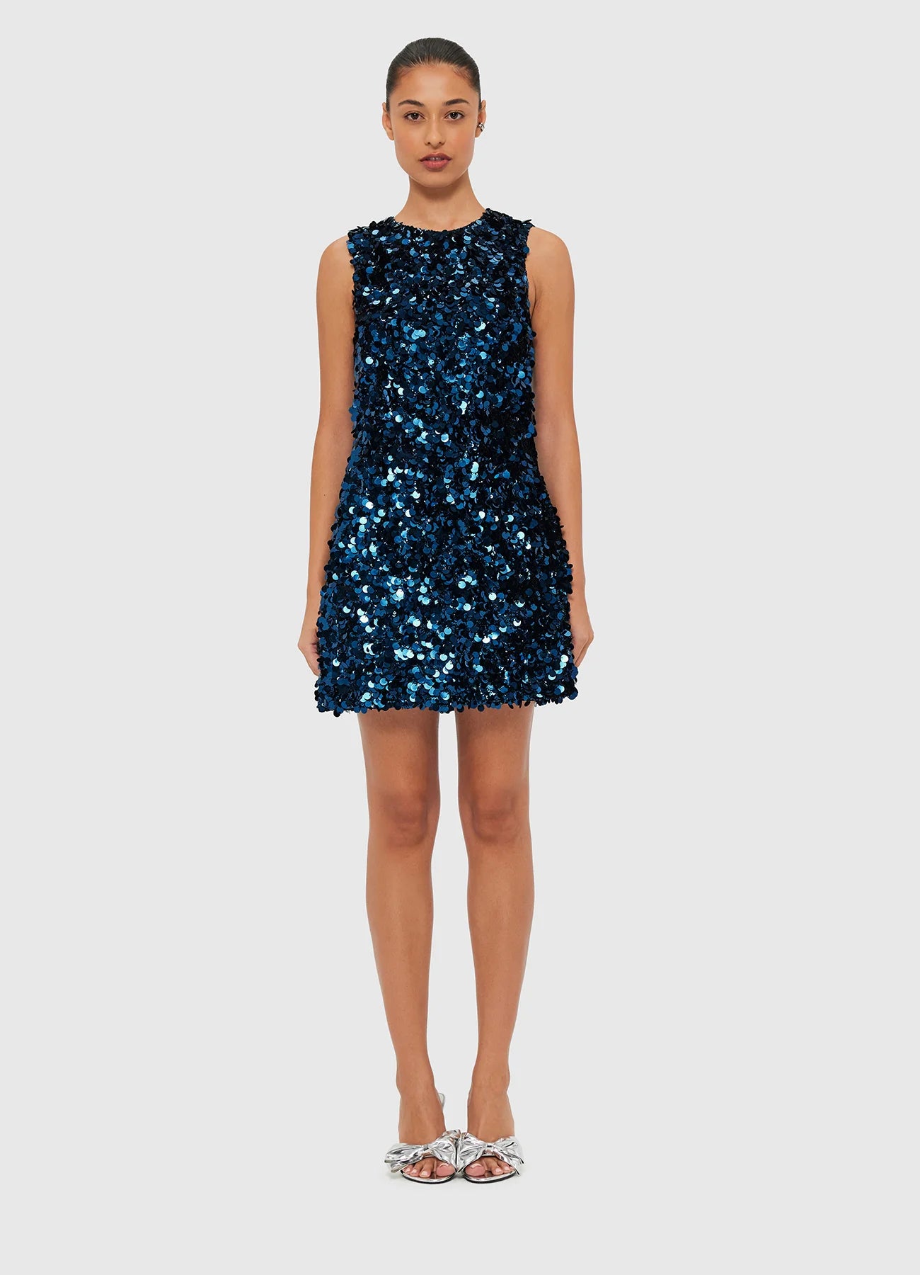 Women wearing LEO LIN midnight blue sequin mini dress with a high scoop neckline and sleeveless design.