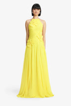 Woman wearing a yellow evening gown on a white background
