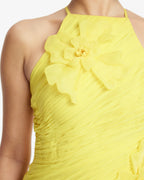 Yellow dress with floral detail on a white background