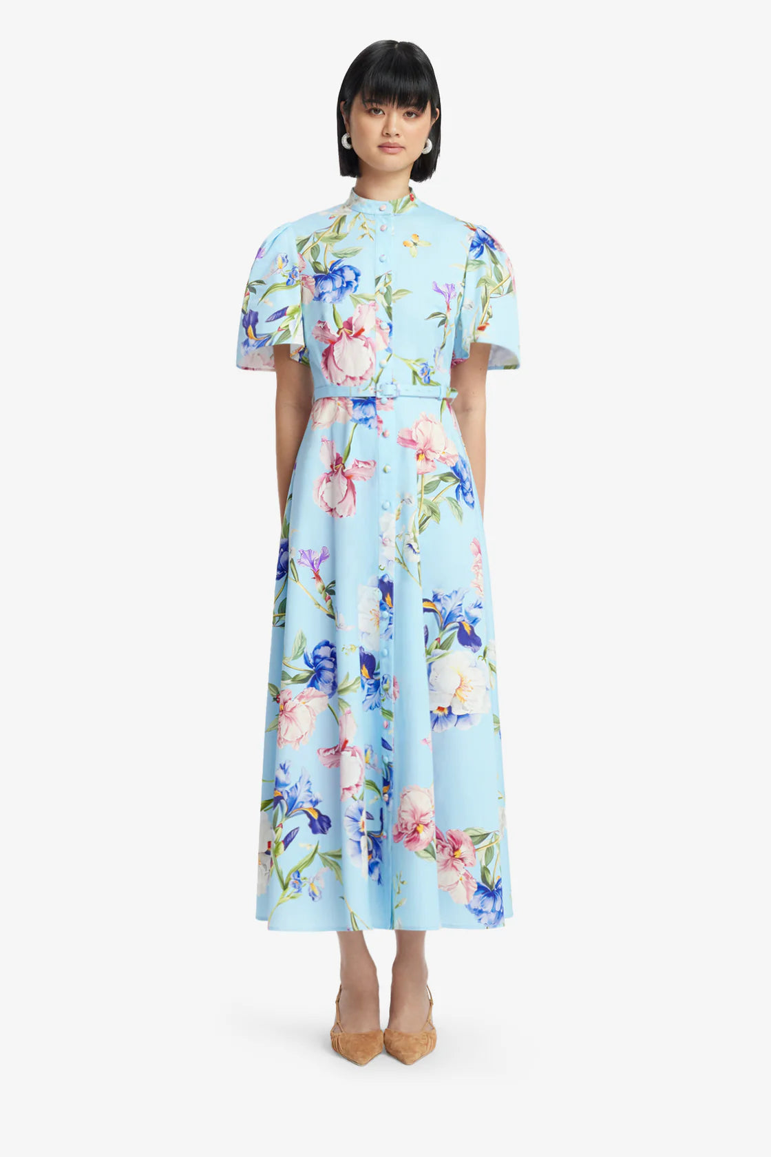 Woman wearing a light blue floral dress on a white background