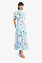 Woman wearing a light blue floral dress on a white background