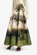 Long skirt with nature-themed design worn by a person on a white background