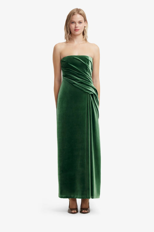 Woman wearing a green strapless gown on a white background