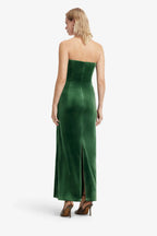 Woman wearing a green strapless gown on a white background