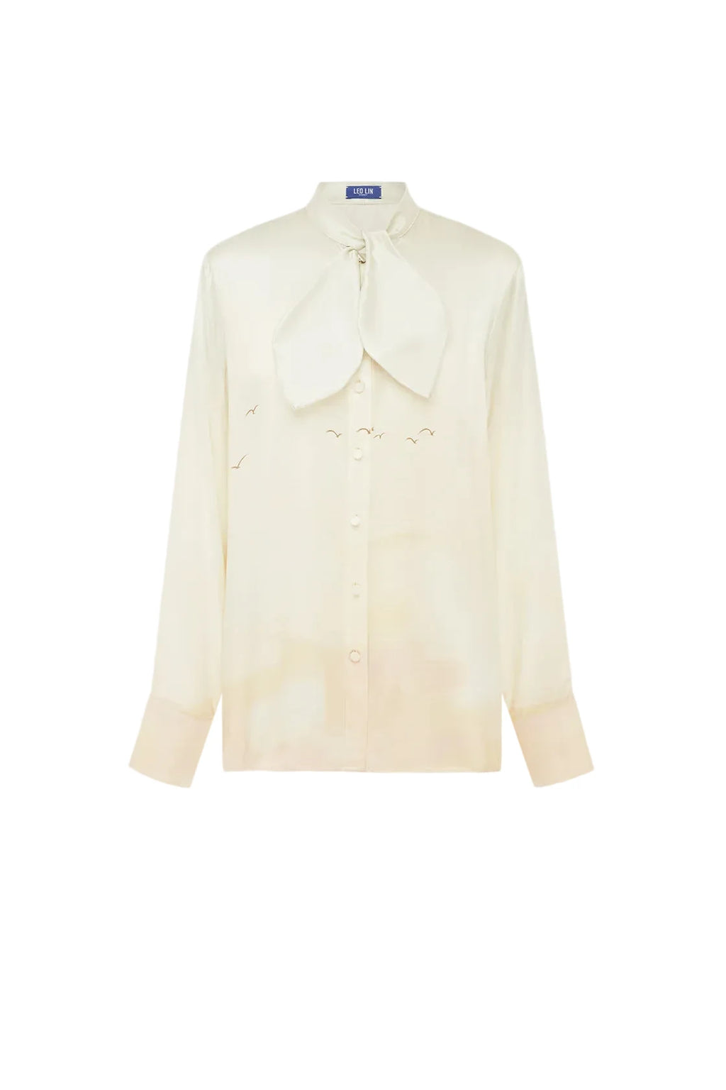 A cream-colored long-sleeve button-up shirt with a large bow tie collar and subtle embroidered bird motifs, displayed on a clean white background.