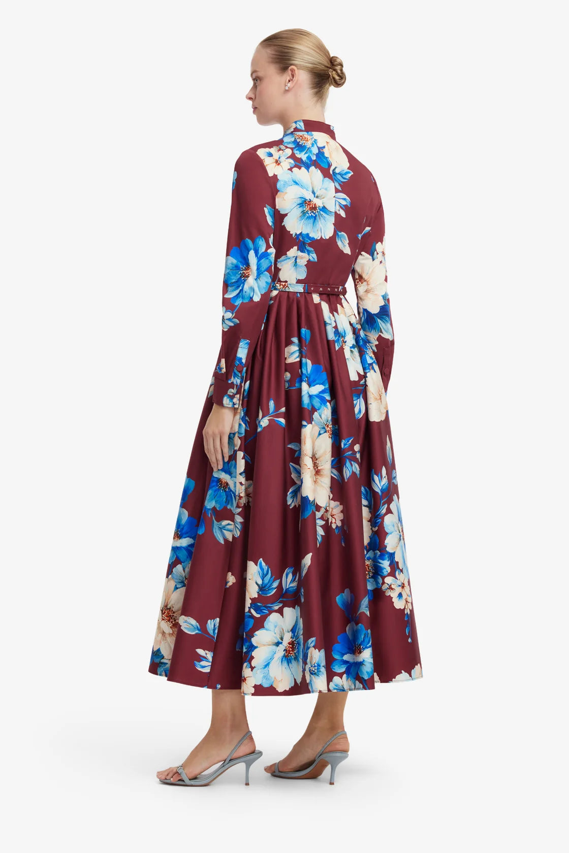 Woman wearing a floral dress with a white background
