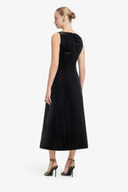 Woman wearing a black dress on a white background