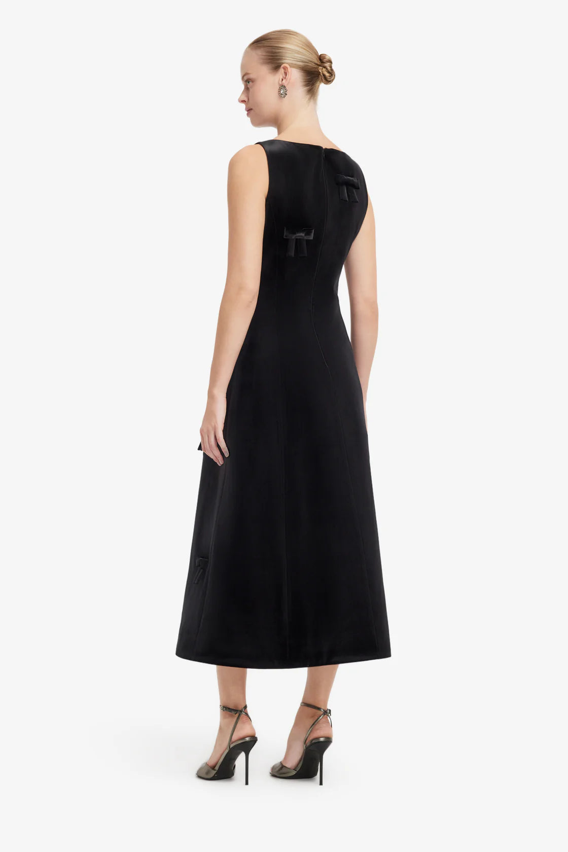 Woman wearing a black dress on a white background