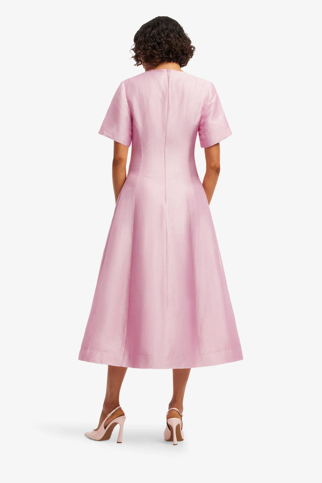 Woman wearing a pink dress on a white background