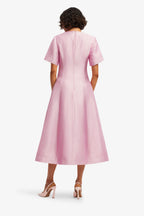 Woman wearing a pink dress on a white background