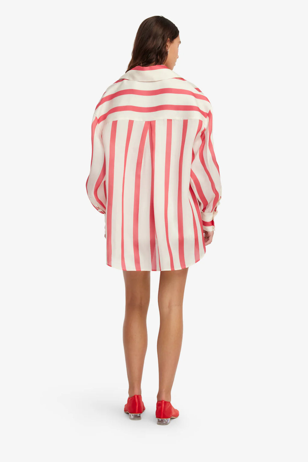 Woman wearing a red and white striped shirt dress on a white background