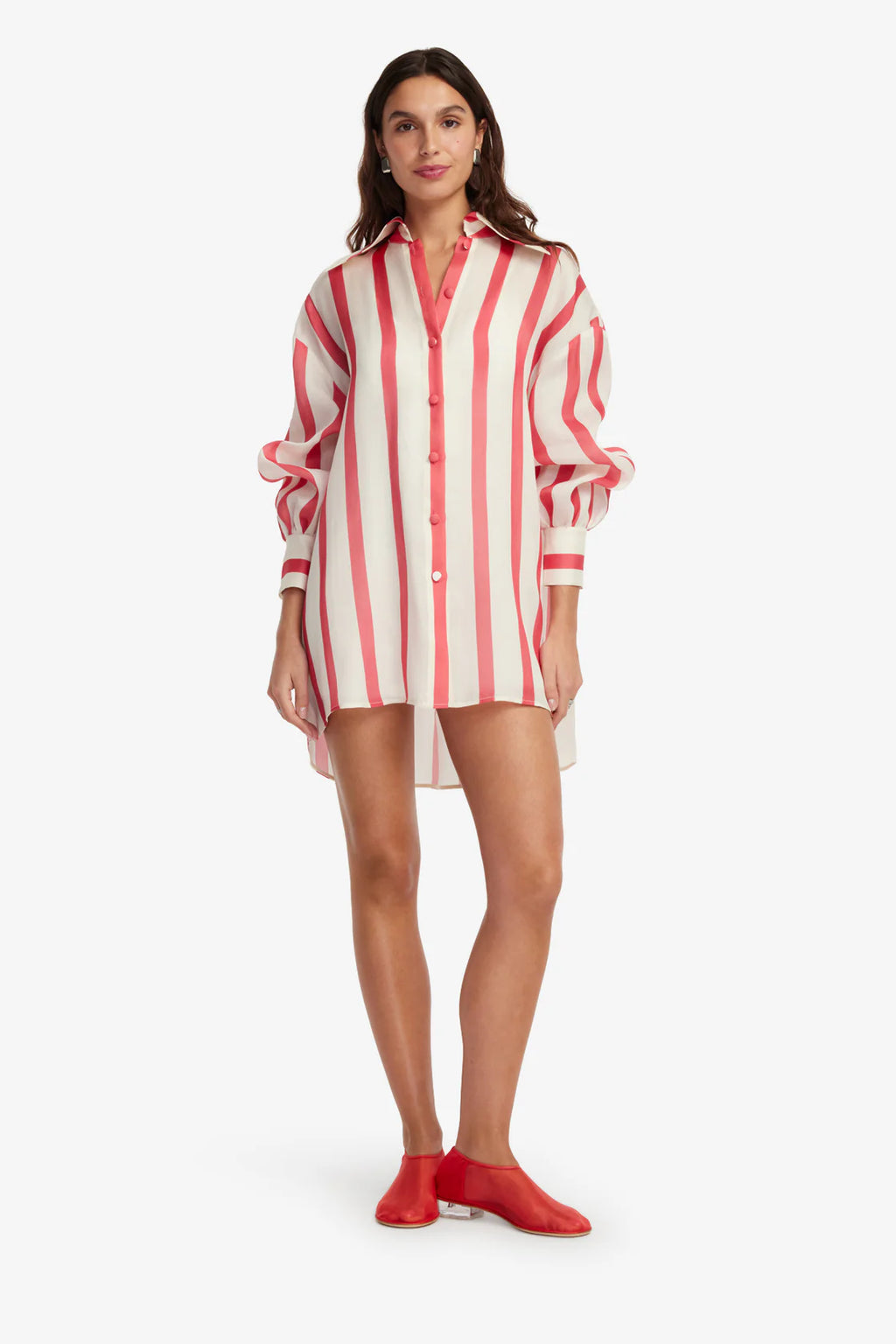 Woman wearing a red and white striped shirt dress on a white background