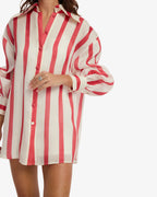 Red and white striped shirt worn by a person on a white background