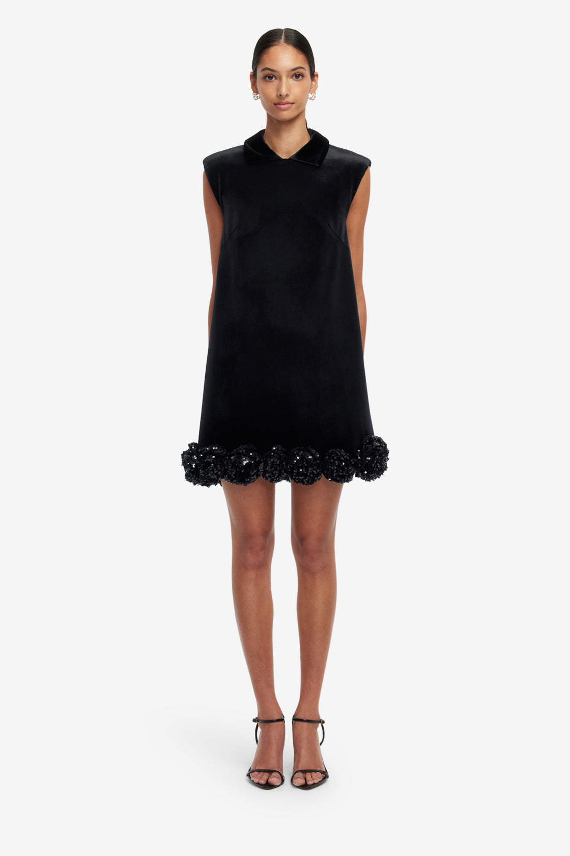 Black sleeveless dress with floral details on a white background