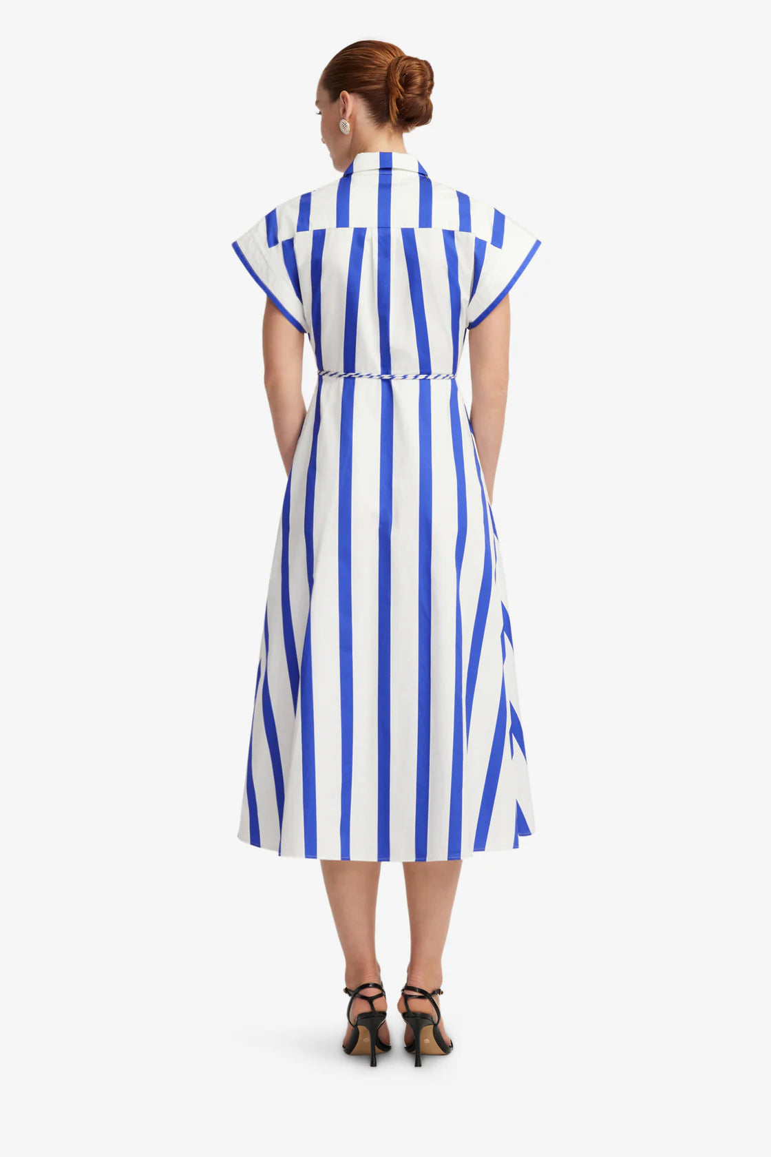 Woman wearing a blue and white striped dress on a white background