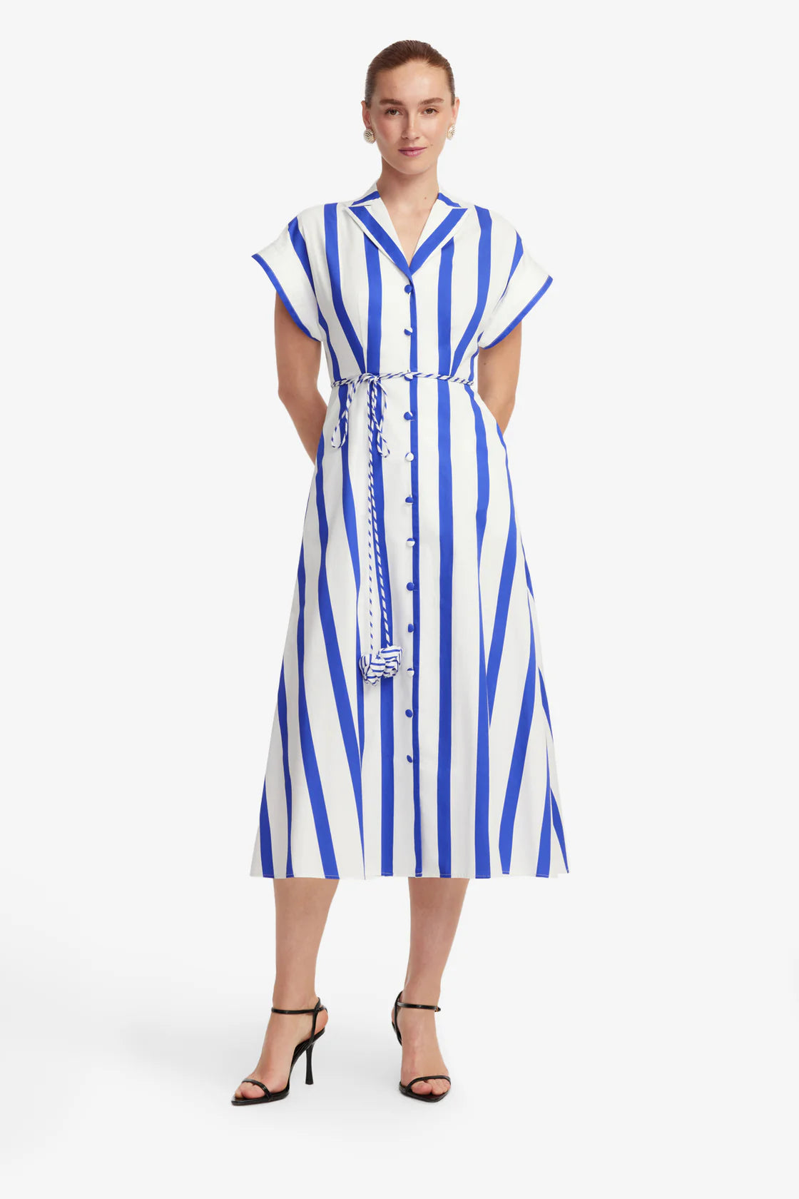 Woman wearing a blue and white striped dress on a white background
