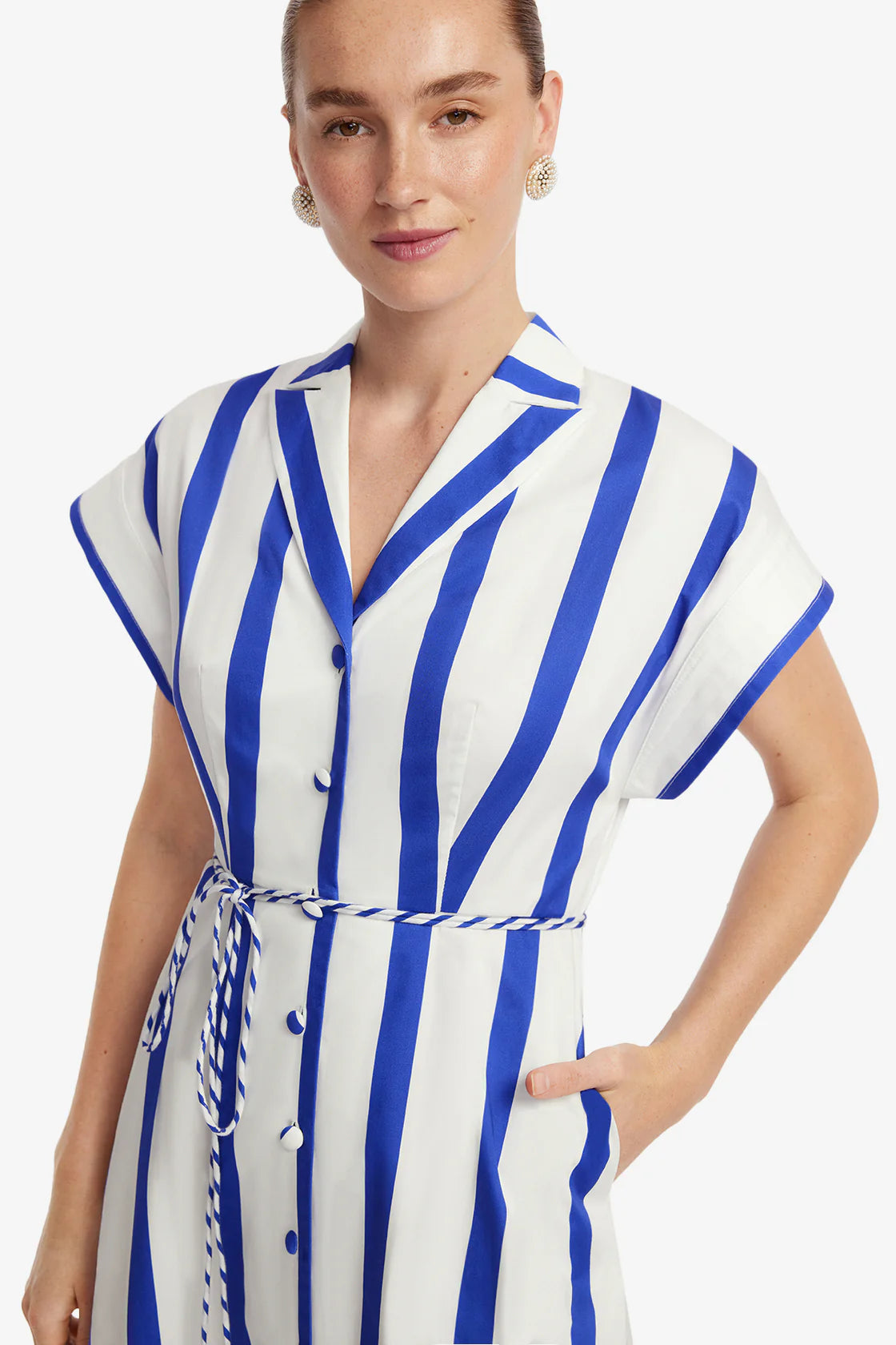 Woman wearing a blue and white striped dress on a white background