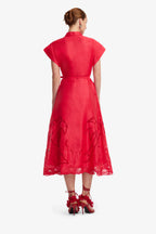 Red dress with lace details on a white background