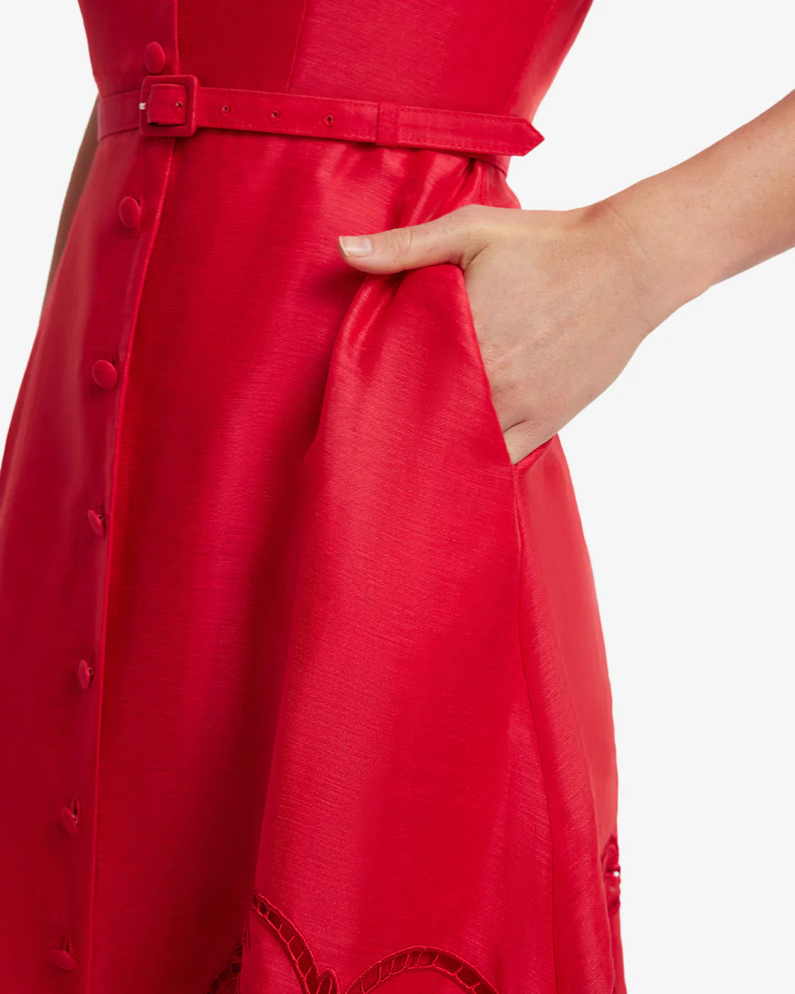 Red dress with a belt and button details on a white background