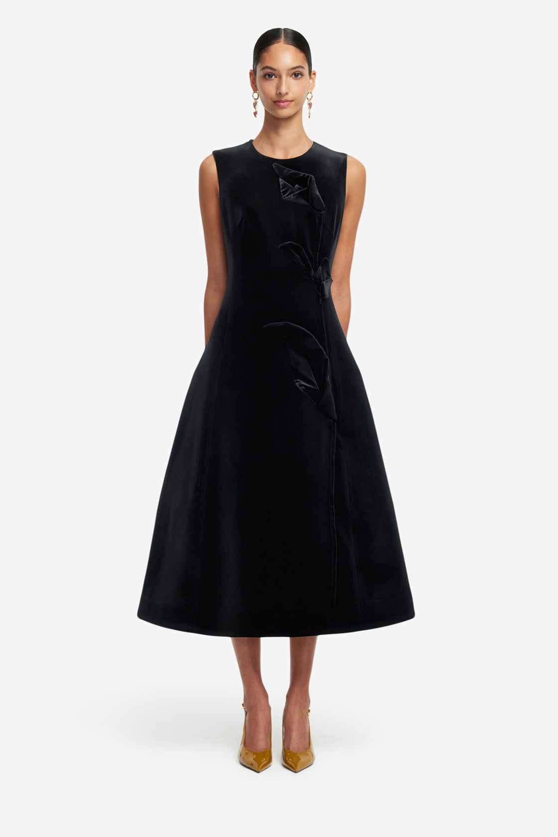 Black dress with a bow detail on a white background
