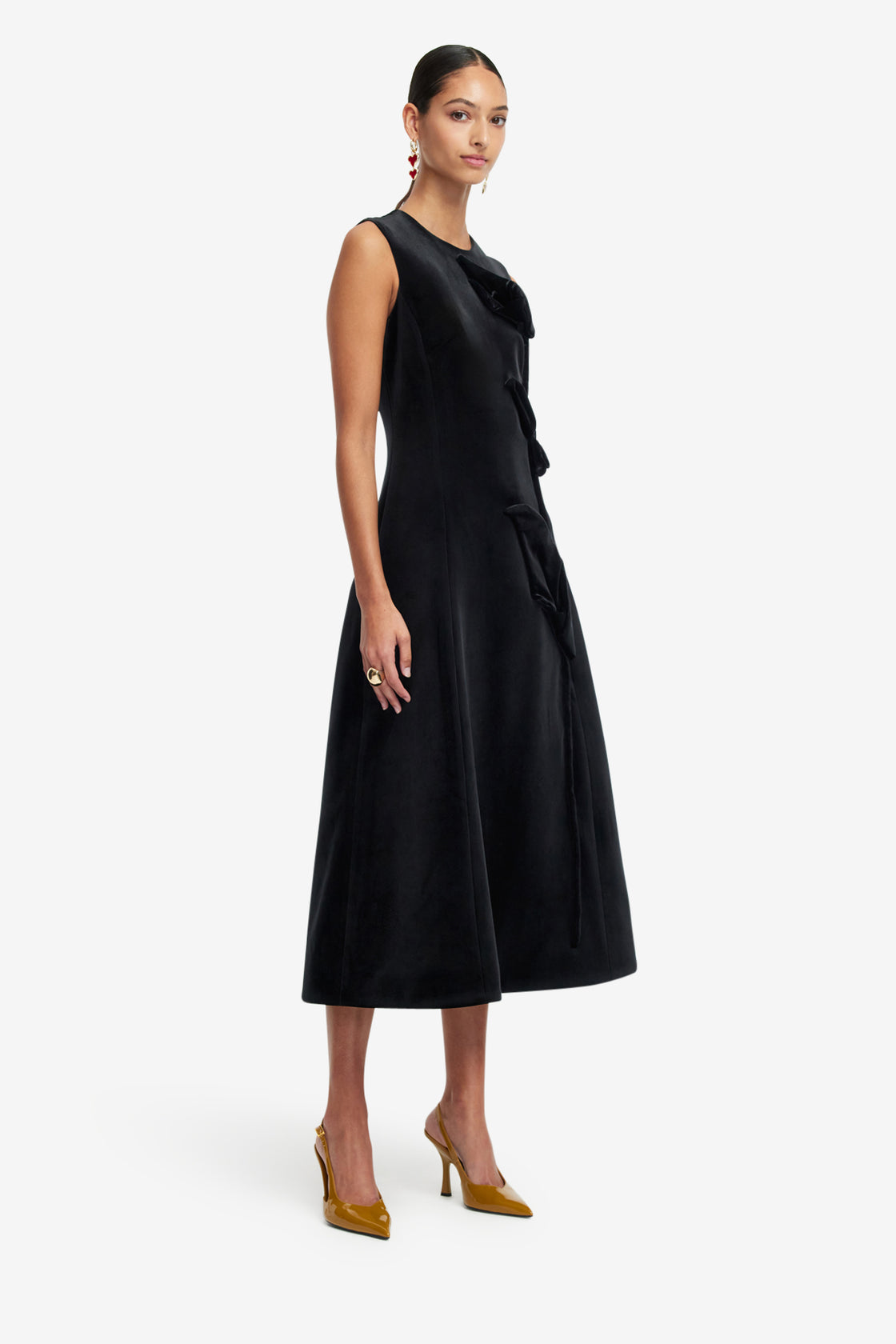 Woman wearing a black sleeveless dress on a white background