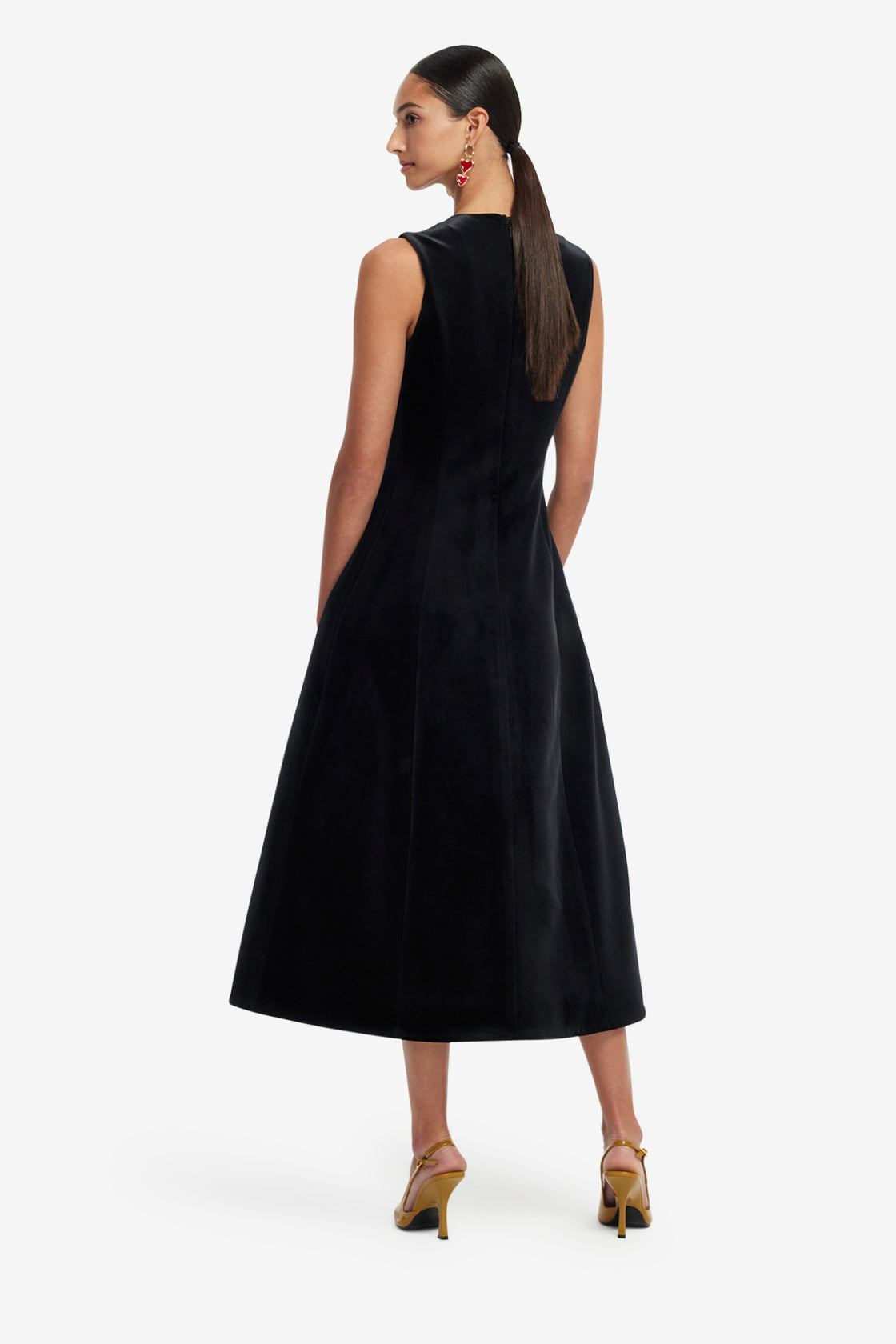 Woman wearing a black sleeveless dress on a white background