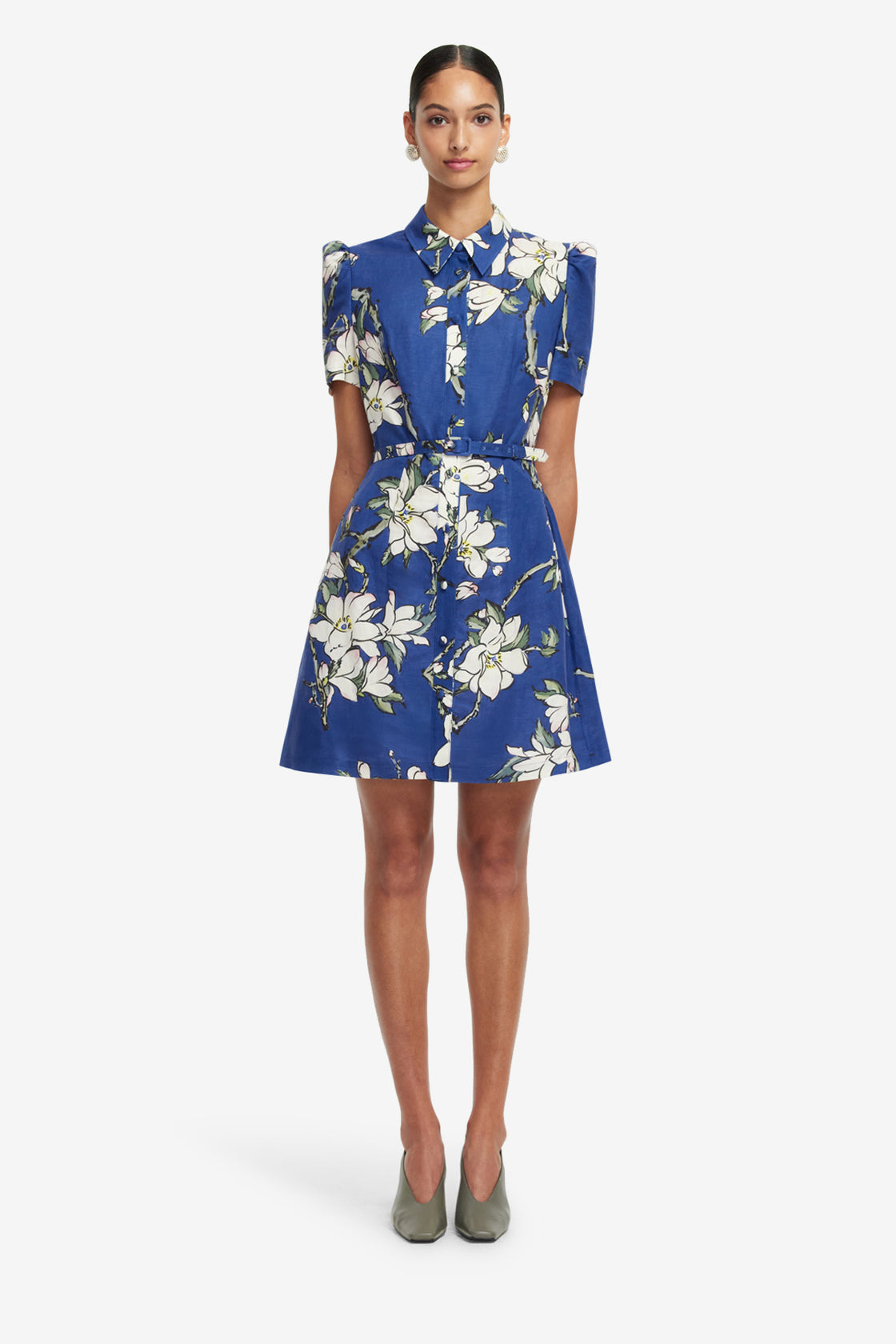 Woman wearing a blue floral dress on a white background