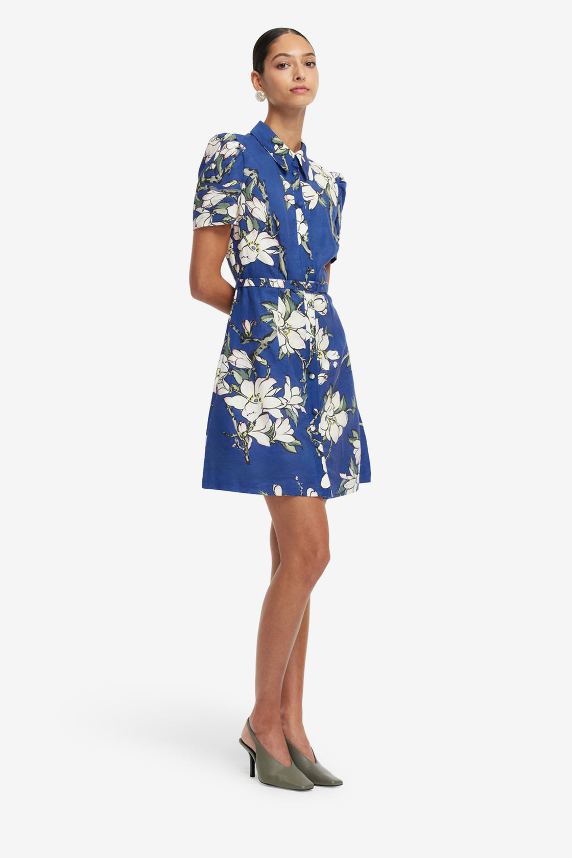 Woman wearing a blue floral dress on a white background